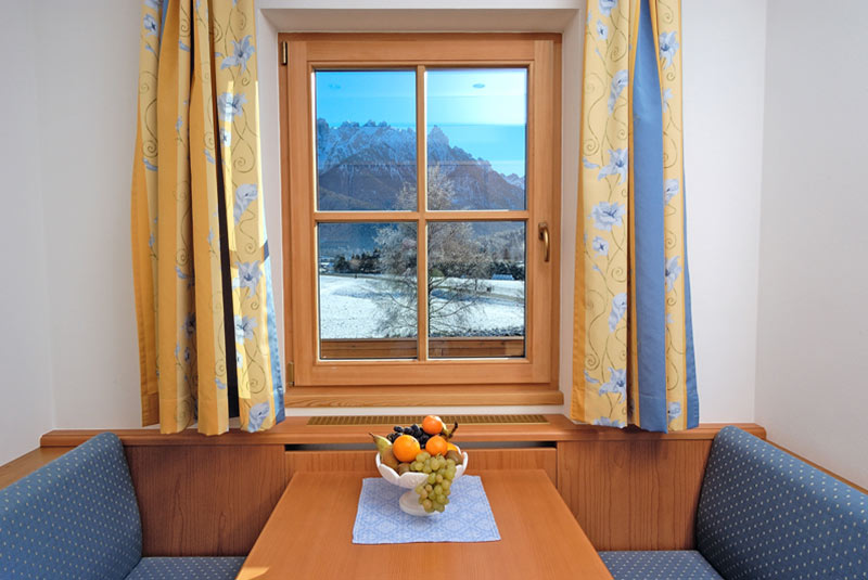Table in front of window with view of winter landscape - Junior Suite - Hotel Hubertushof